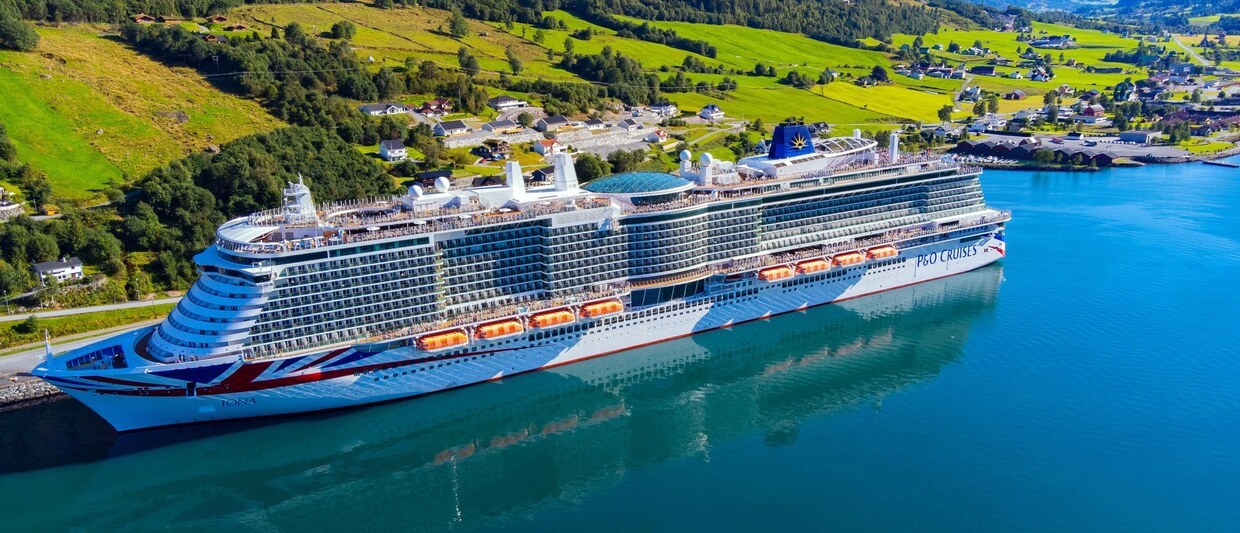 2K19WY8 P&O Cruise Ship Iona in the Norwegian Fjords. Nestled on the Nordfjorden, Olden is a popular port for cruise companies. Beautiful water on a sunny day
