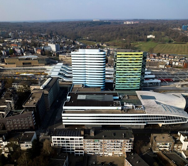 2JKNH6M Aerial of contemporary modern architecture of central bus and train station rising above the city.
